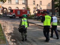 Na zdjęciu biegły sądowy i policjanci w trakcie czynności na miejscu pożaru szkoły w Lublińcu.